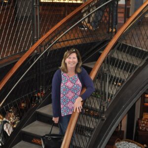 Jill standing on gorgeous spiral staircase