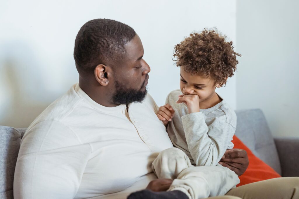 Father and son sitting on couch